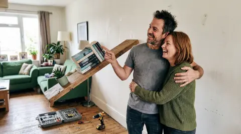 Photo 4: the couple admiring the crooked shelf, arm in arm