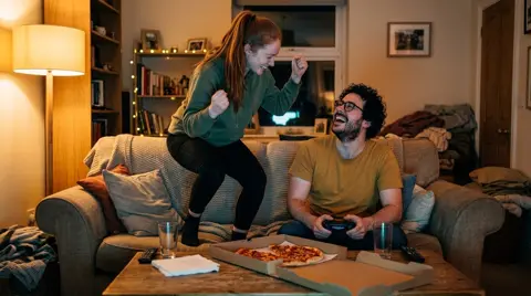 Photo 3: her doing a victory dance on the couch cushions