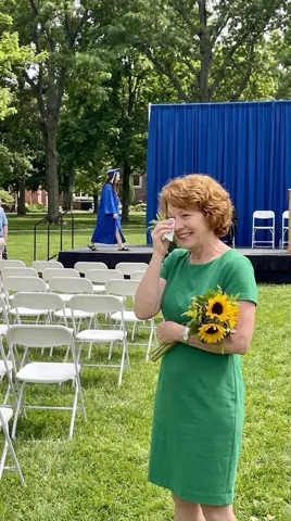 Photo 3: the mother wiping a tear as her daughter crosses the stage