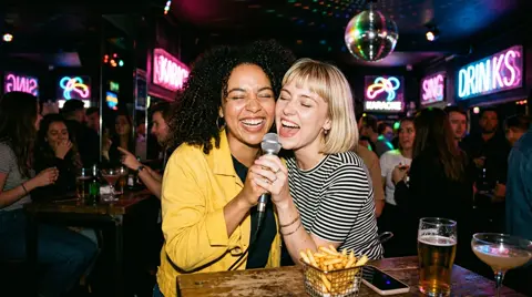 The first photo: two best friends sharing a microphone at karaoke