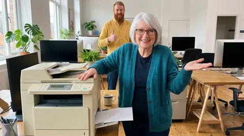 Photo 2: her patting the office printer while a coworker gives a thumbs up